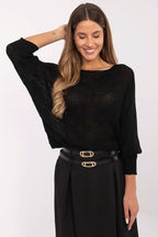 Woman wearing a black outfit with a belt on a white background