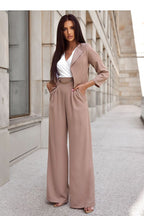 Woman wearing a beige suit with a white top in an urban setting