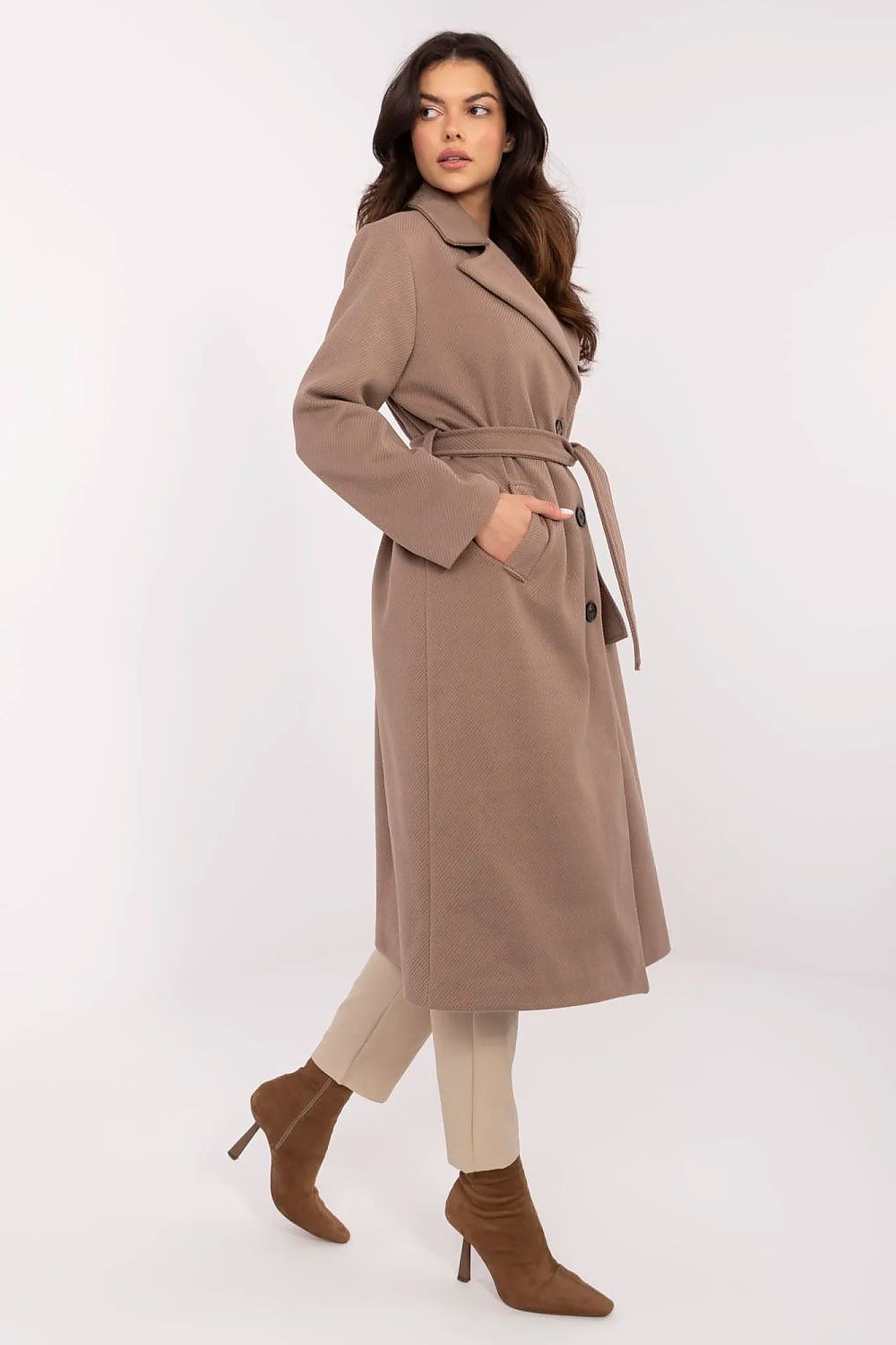 Woman wearing a long brown coat on a white background