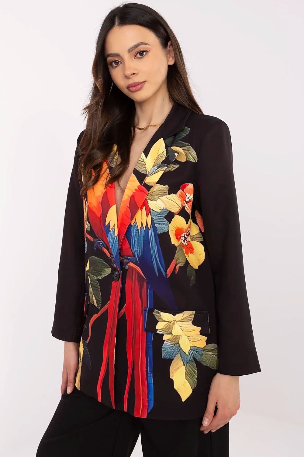 Woman wearing a black jacket with colorful parrot embroidery on a white background