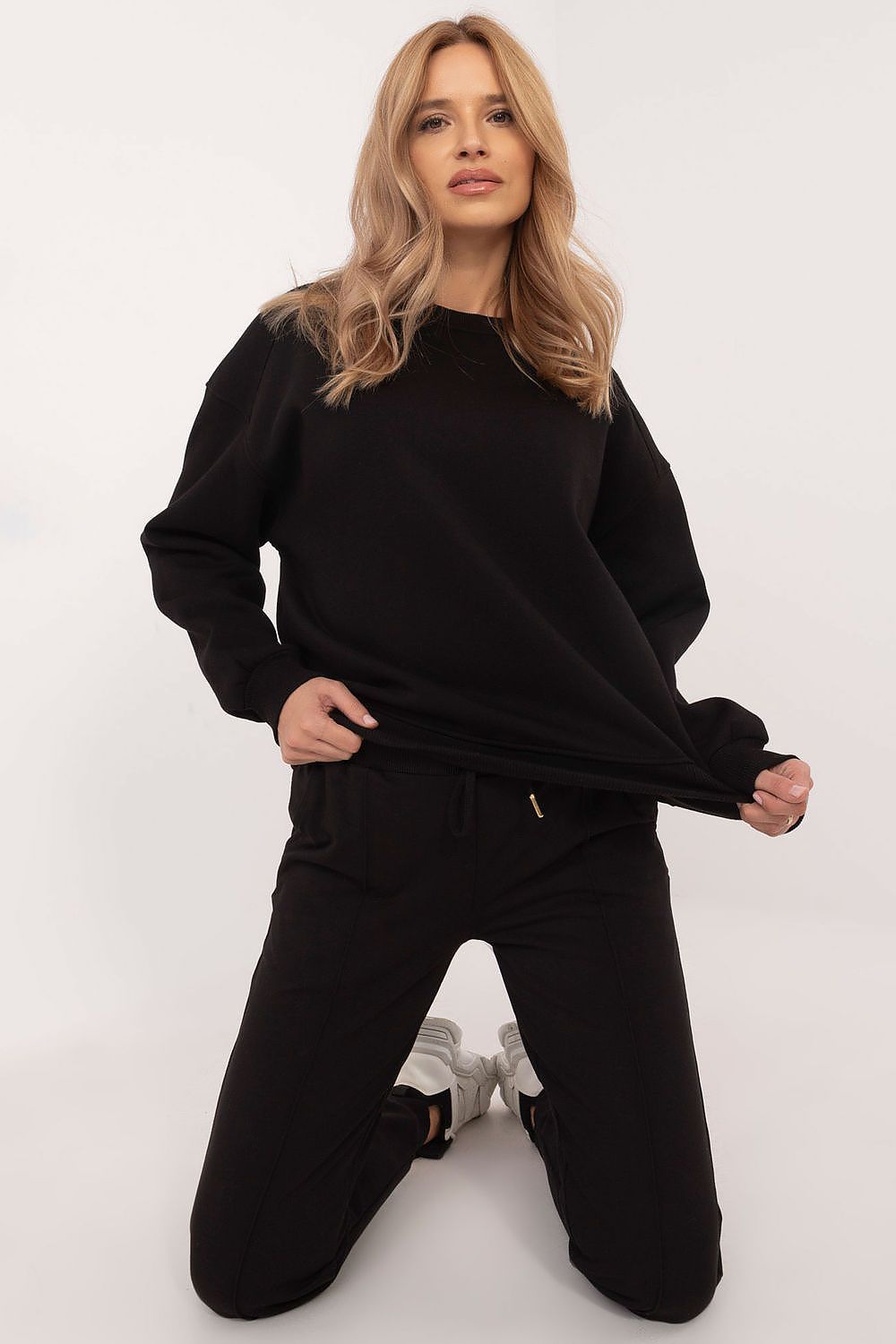 Woman wearing a black outfit on a white background