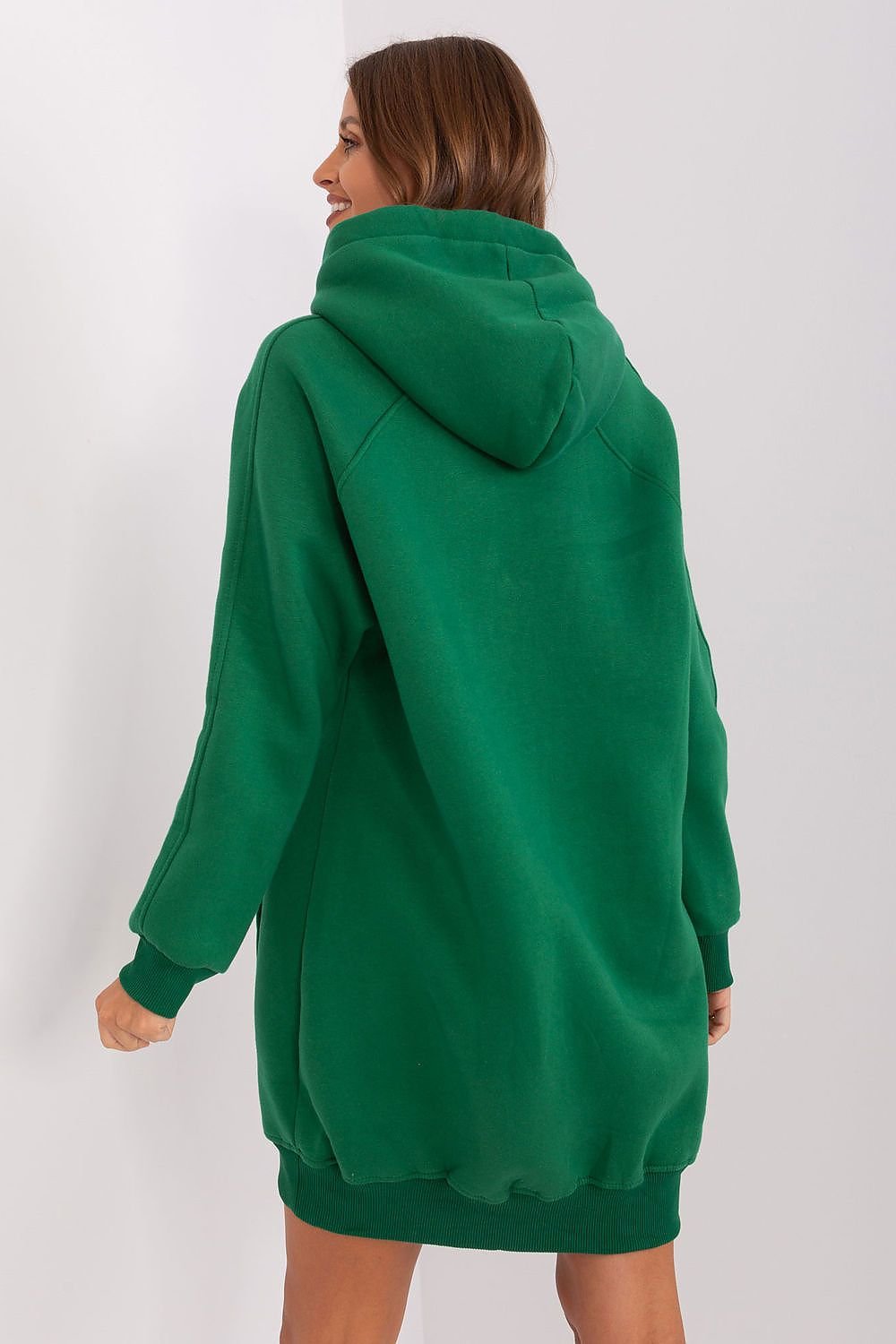 Green hoodie worn by a person on a white background