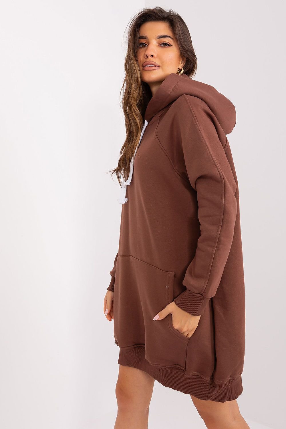 Woman wearing a brown hoodie on a white background