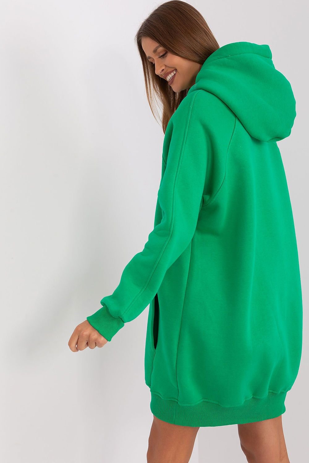Person wearing a green hoodie on a white background