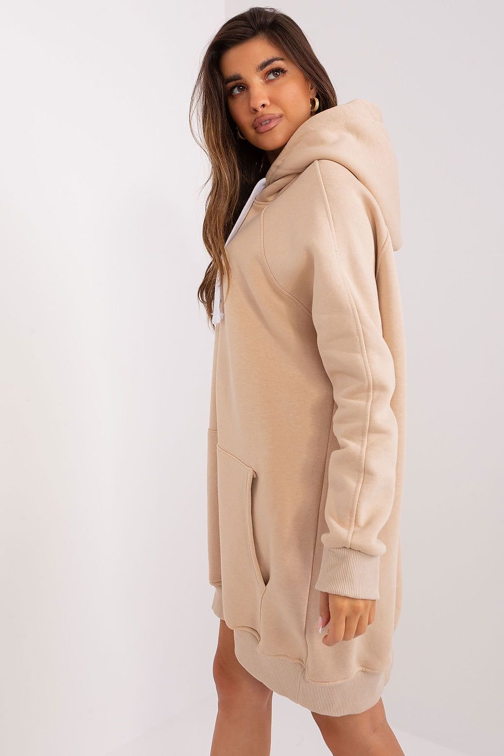 Woman wearing a beige hoodie on a white background