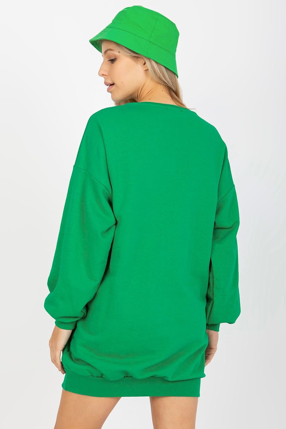 Person wearing a green sweatshirt and hat on a white background