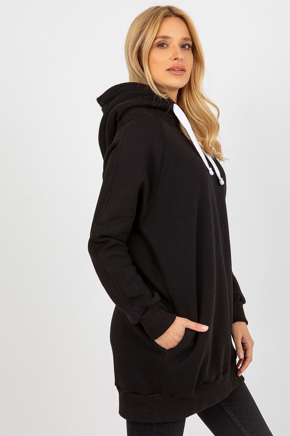 Woman wearing a black hoodie on a white background