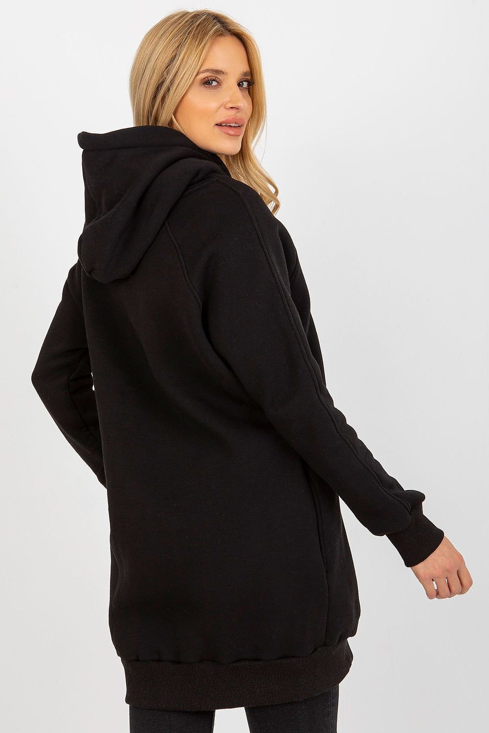 Woman wearing a black hoodie on a white background