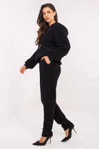 Woman wearing a black outfit with a white background