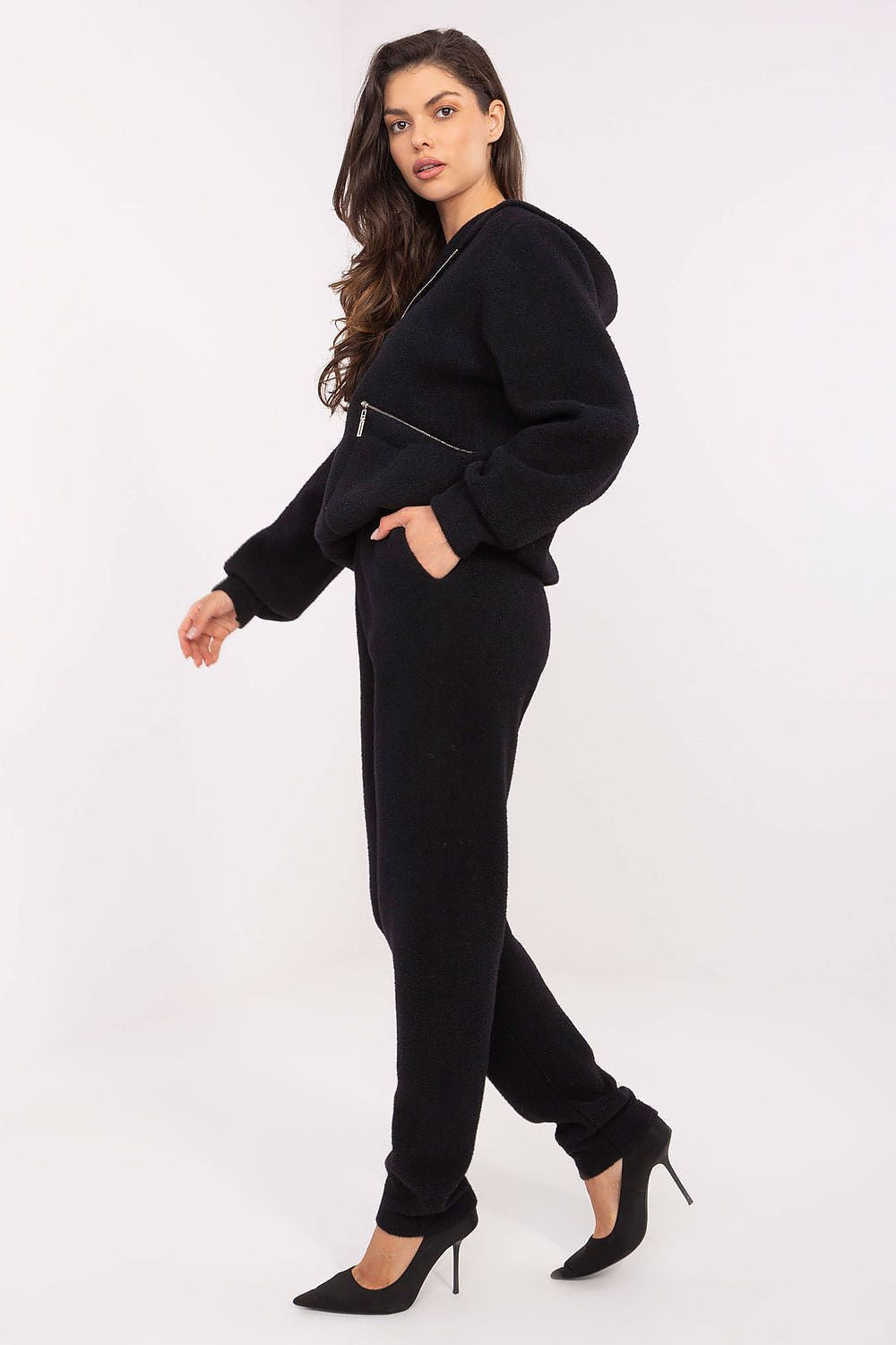 Woman wearing a black outfit with a white background