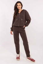 Woman wearing a brown tracksuit on a white background