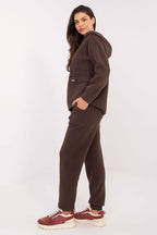 Woman wearing a brown tracksuit on a white background