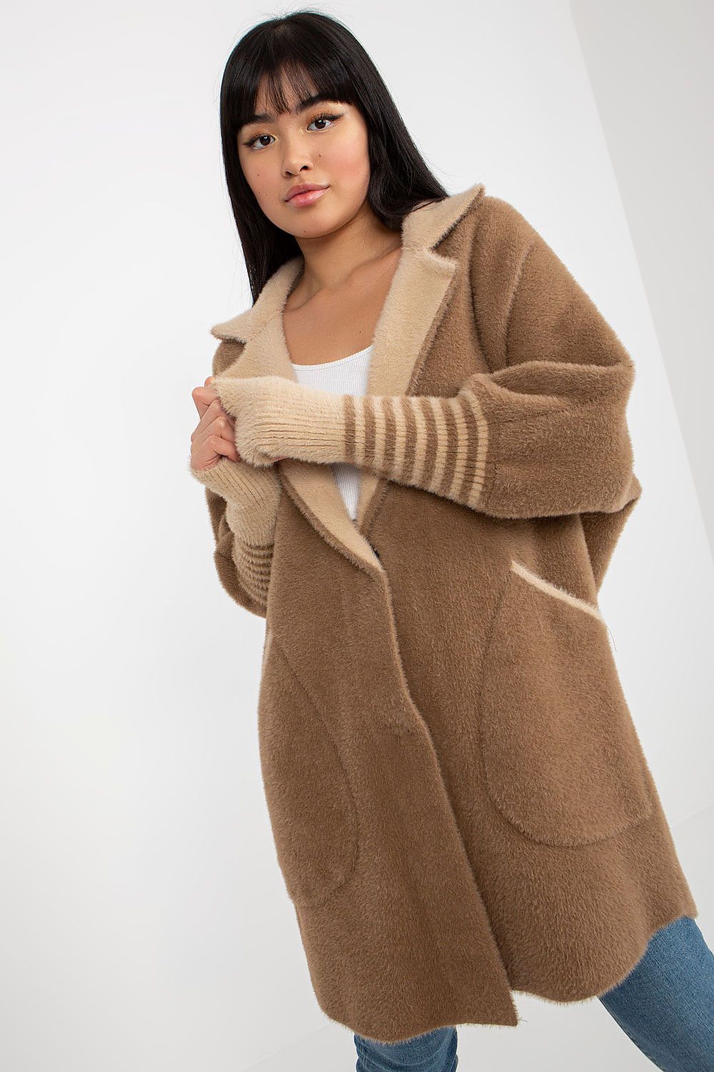 Woman wearing a brown cardigan with a white background