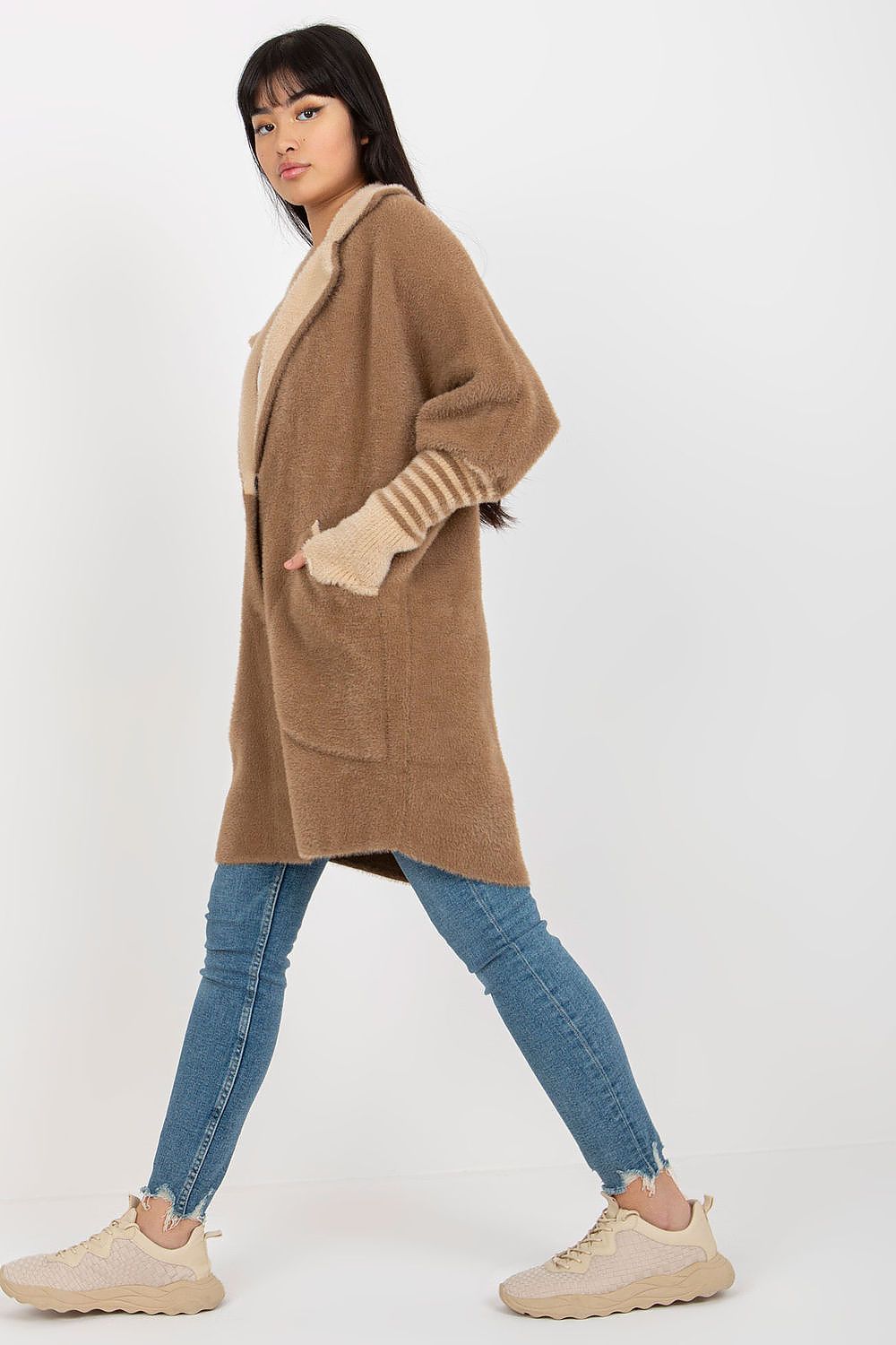 Woman wearing a brown coat with a white background