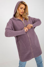Woman wearing a purple hooded coat on a white background
