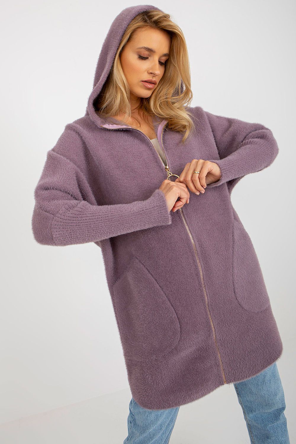 Woman wearing a purple hooded coat on a white background