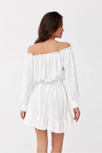 Woman wearing a white off-shoulder dress on a white background
