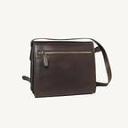 "Full-grain calfskin leather shoulder bag with three compartments, zippered rear pocket, and adjustable shoulder strap"
