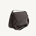 "Full-grain calfskin leather shoulder bag with three compartments, zippered rear pocket, and adjustable shoulder strap"
