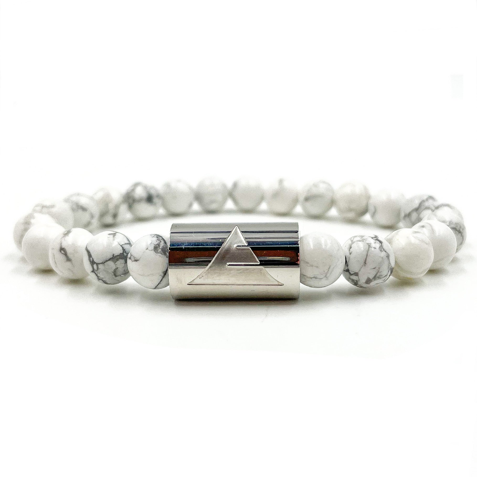 Bracelet with white beads and silver cylindrical clasp on a white background