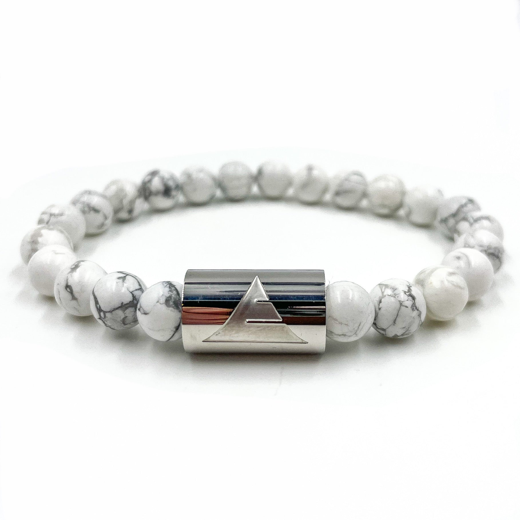 Bracelet with white beads and silver cylindrical clasp on a white background
