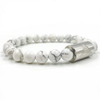 White marbled beaded bracelet with a silver cylindrical clasp on a white background