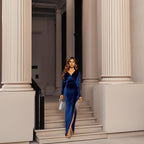 Woman wearing the Dariana Velvet Fringe High Split Dress, featuring rich velvet, a dramatic thigh-high split, and vintage-inspired fringe — perfect for red carpet and glamorous events.
