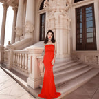 Elegant woman wearing the Evelyn Belluci Red Strapless Gown, featuring a sculpted neckline and flowing maxi silhouette, perfect for glamorous evening occasions.