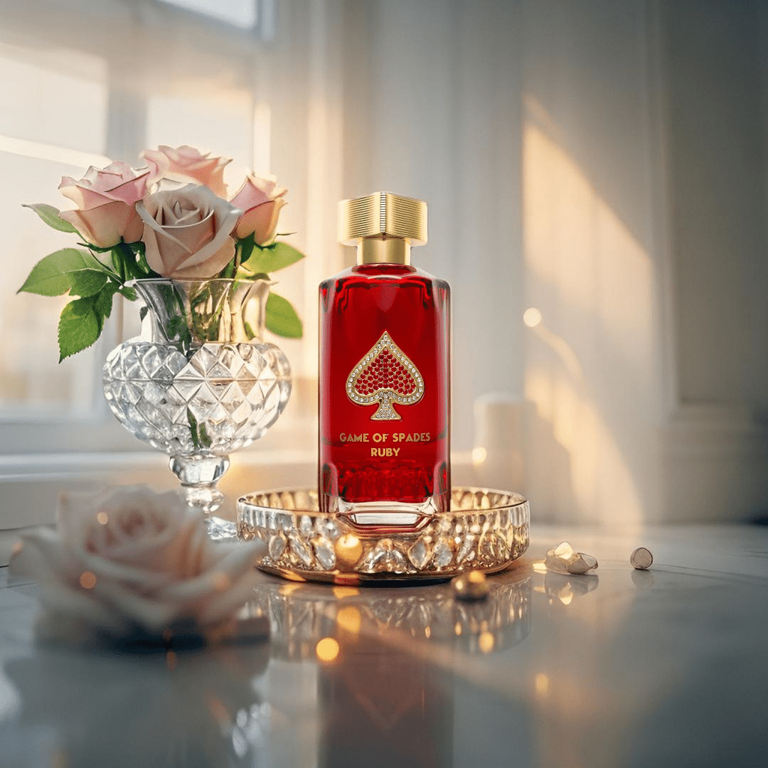 "Jo Milano Paris Game of Spades Ruby 3 oz Parfum Spray – a luxurious ruby-red glass bottle adorned with a gold-toned cap and an embellished spade emblem, reflecting elegance and sophistication."