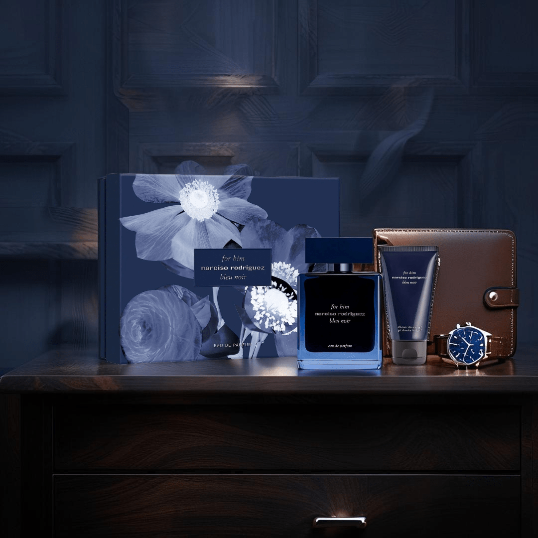 "Narciso Rodriguez For Him Bleu Noir 3-Piece Set featuring a 3.3 oz Eau de Parfum bottle, a 0.33 oz travel-size spray, and a 1.6 oz shower gel, all presented in a sleek navy gift box."