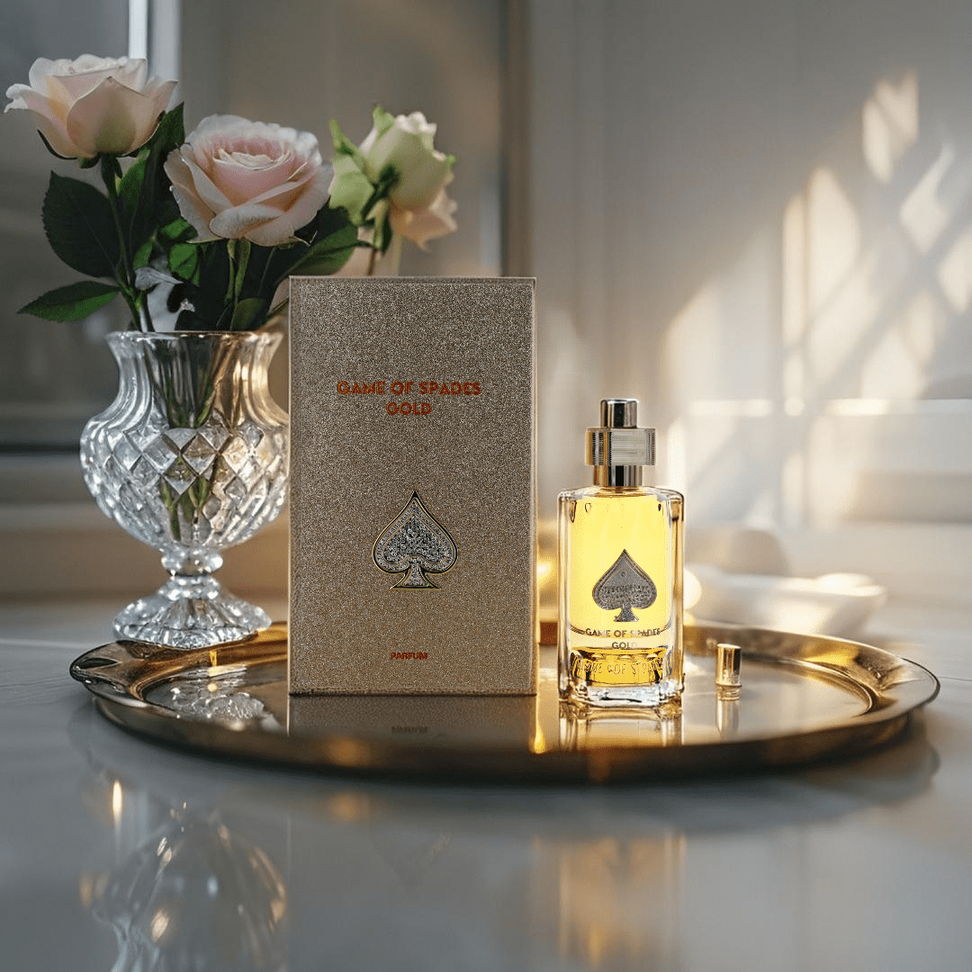 "Jo Milano Paris Game of Spades Gold 3 oz Parfum Spray – a luxurious gold-toned bottle adorned with an embossed spade emblem, reflecting elegance and sophistication."