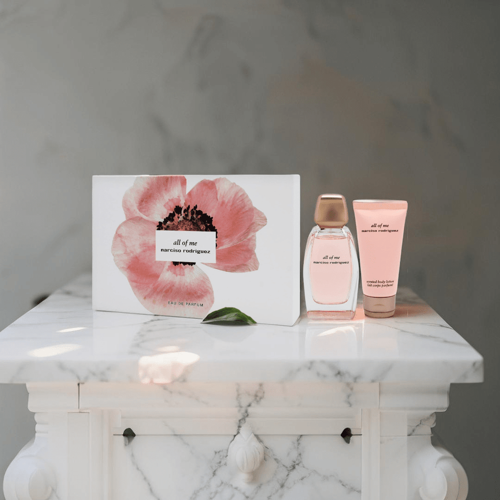 "Narciso Rodriguez All Of Me 3-Piece Gift Set for Women featuring a 3 oz Eau de Parfum Spray, a 1.6 oz Body Lotion, and a 0.34 oz Eau de Parfum Travel Spray, elegantly packaged in a chic pink box."