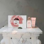 "Narciso Rodriguez All Of Me 3-Piece Gift Set for Women featuring a 3 oz Eau de Parfum Spray, a 1.6 oz Body Lotion, and a 0.34 oz Eau de Parfum Travel Spray, elegantly packaged in a chic pink box."