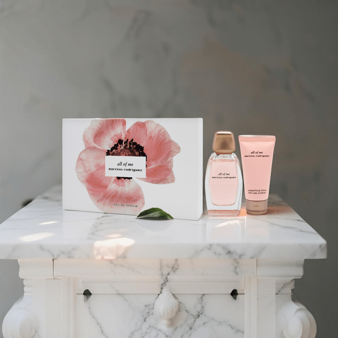 "Narciso Rodriguez All Of Me 3-Piece Gift Set for Women featuring a 3 oz Eau de Parfum Spray, a 1.6 oz Body Lotion, and a 0.34 oz Eau de Parfum Travel Spray, elegantly packaged in a chic pink box."