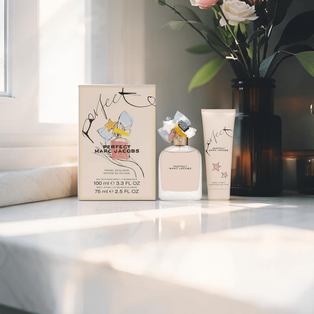 "Marc Jacobs Perfect 2-Piece Gift Set featuring a 3.3 oz Eau de Parfum Spray and a 2.5 oz Body Lotion, elegantly packaged in a pastel pink box adorned with whimsical illustrations."