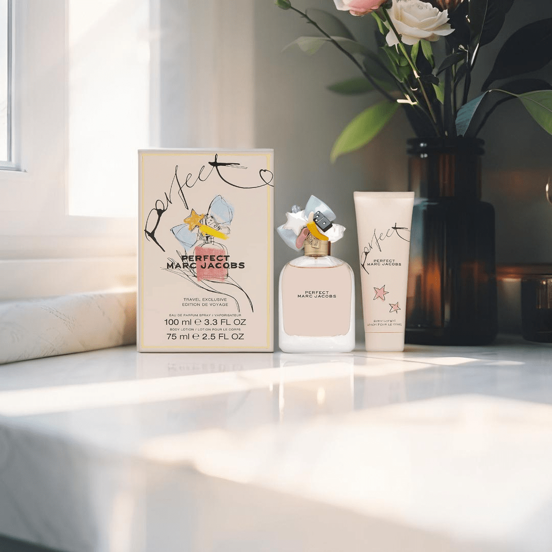 "Marc Jacobs Perfect 2-Piece Gift Set featuring a 3.3 oz Eau de Parfum Spray and a 2.5 oz Body Lotion, elegantly packaged in a pastel pink box adorned with whimsical illustrations."