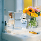 "Marc Jacobs Daisy Dream Eau de Toilette 3.4 oz – a sky-blue glass bottle adorned with delicate white daisies on the cap and shoulders, reflecting a dreamy and feminine design."