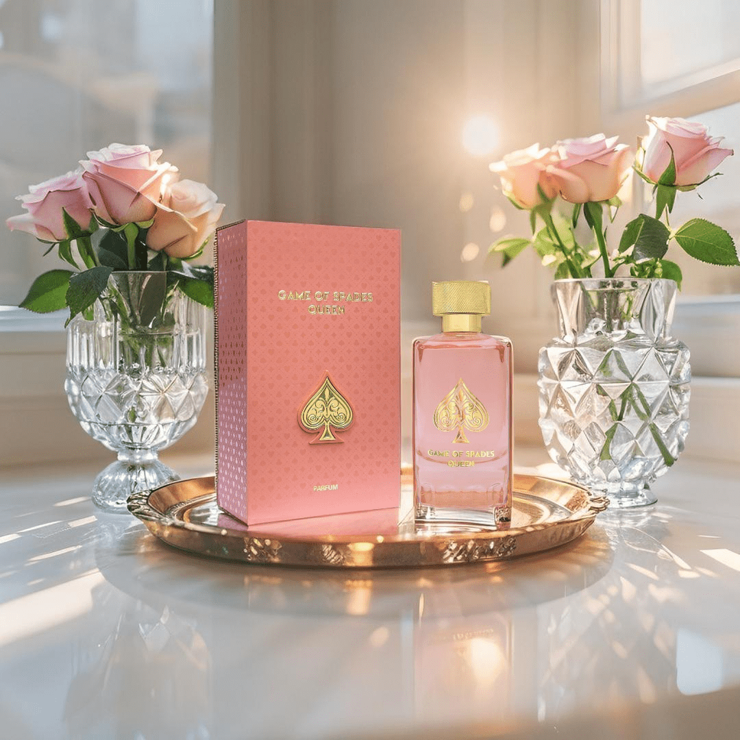 "Jo Milano Paris Game of Spades Queen 3.4 oz Parfum Spray – a luxurious pink-hued glass bottle adorned with a gold-toned cap and an embossed spade emblem, reflecting elegance and sophistication."