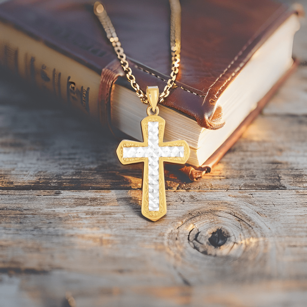 14k two-tone gold cross pendant with high polish finish and diamond cut detailing.