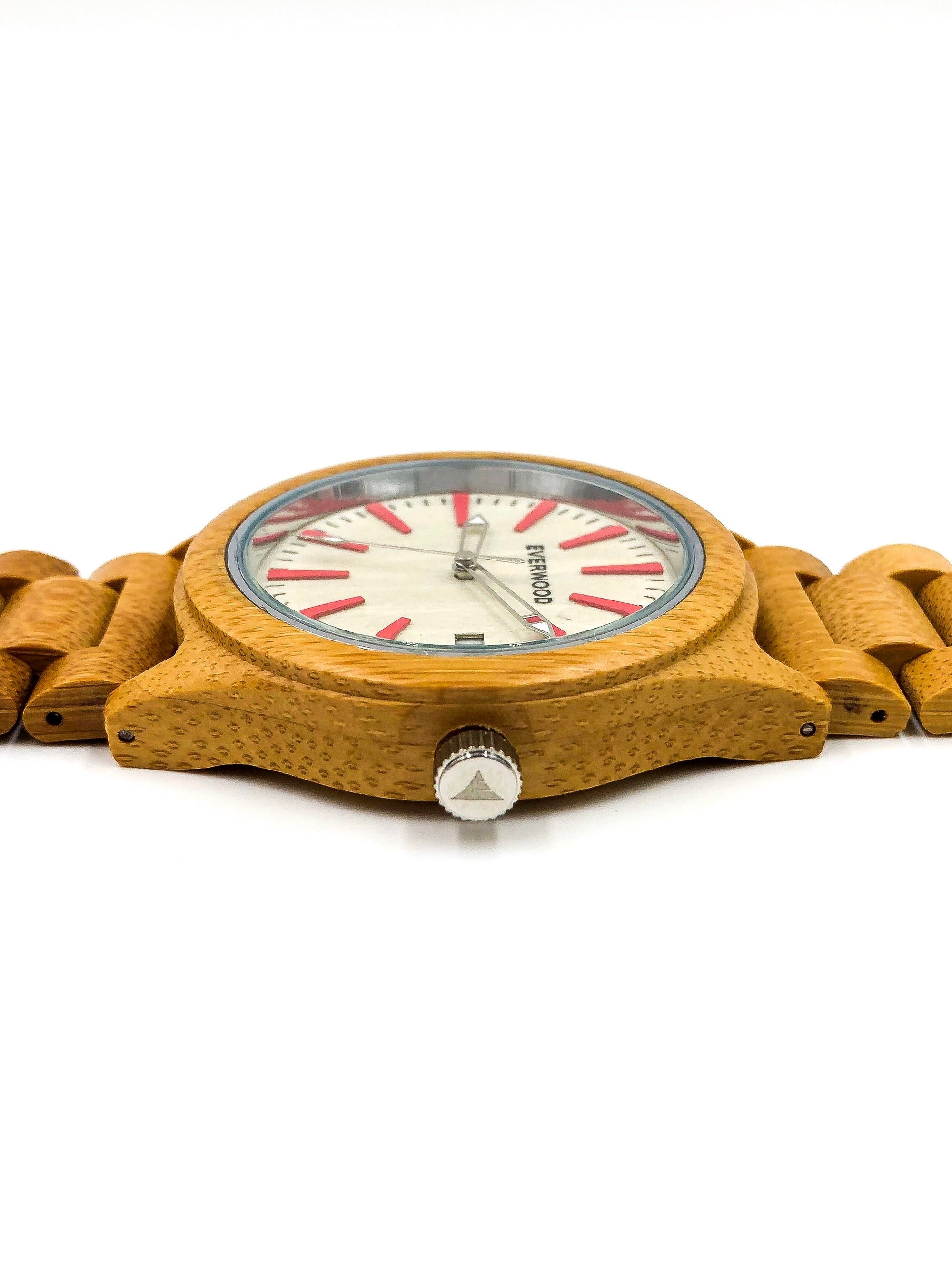 Wooden watch with a white face and red accents on a white background