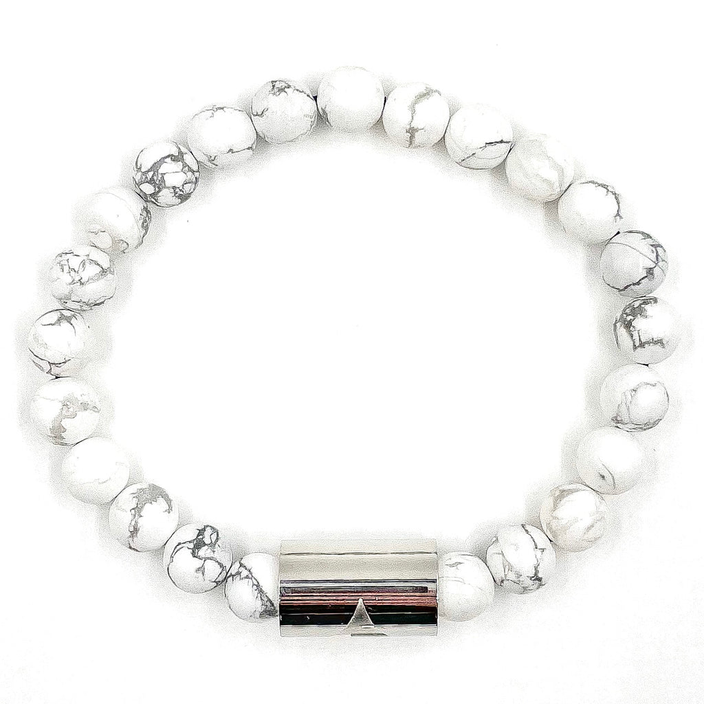 White beaded bracelet with a silver clasp on a white background