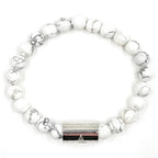 White beaded bracelet with a silver clasp on a white background