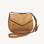 "Elegant full-grain calfskin leather shoulder bag with zippered front and back pockets, three compartments, and adjustable strap"