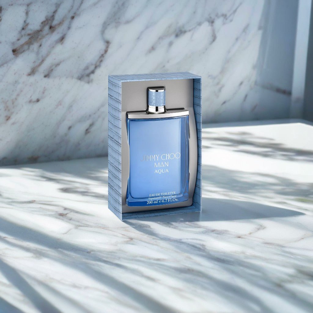 "Jimmy Choo Man Aqua 6.7 oz Eau de Toilette Spray – a sleek, ocean-blue bottle with a silver-toned cap, exuding freshness and modern masculinity."