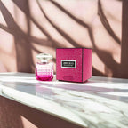 "Jimmy Choo Blossom 3.4 oz Eau de Parfum spray for women – fruity and floral fragrance in a vibrant pink bottle."
