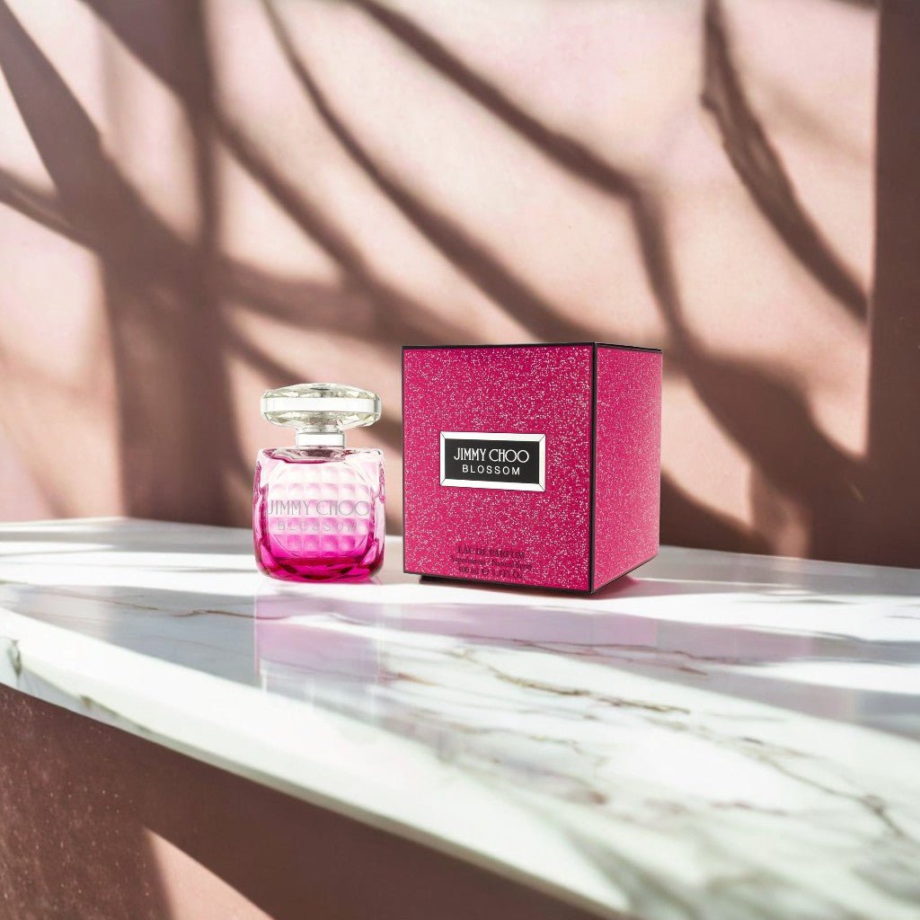 "Jimmy Choo Blossom 3.4 oz Eau de Parfum spray for women – fruity and floral fragrance in a vibrant pink bottle."