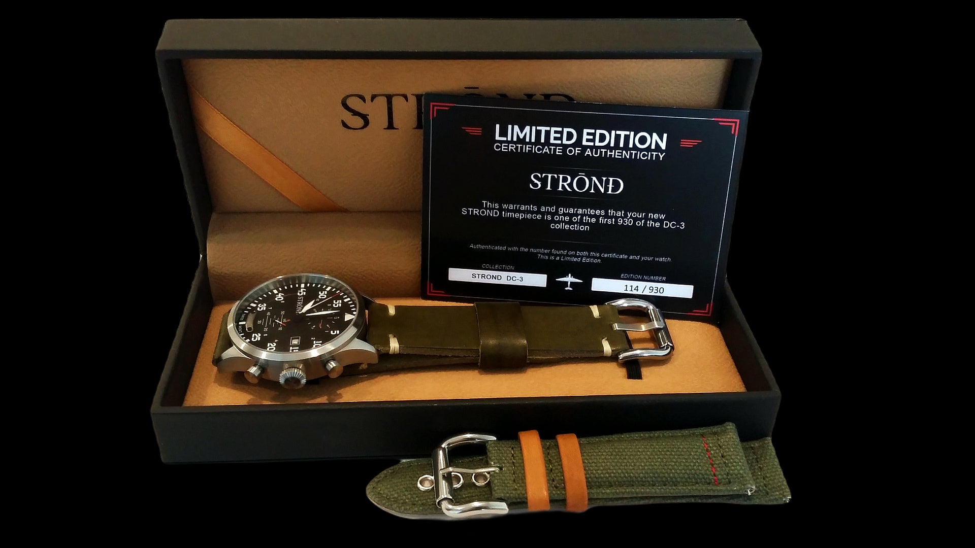 Strand watch with strap and certificate in open box on black background