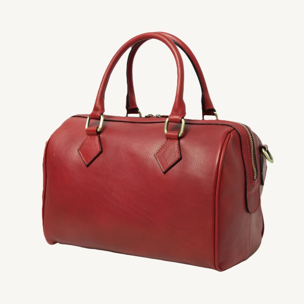 Elegant full-grain leather shoulder bag, 31x20x18 cm, with double handles, two interior zipped pockets, adjustable/removable strap, bottom feet, and polyester lining.