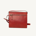 "Full-grain calfskin leather shoulder bag with three compartments, zip closure, rear zip pocket, and adjustable strap"