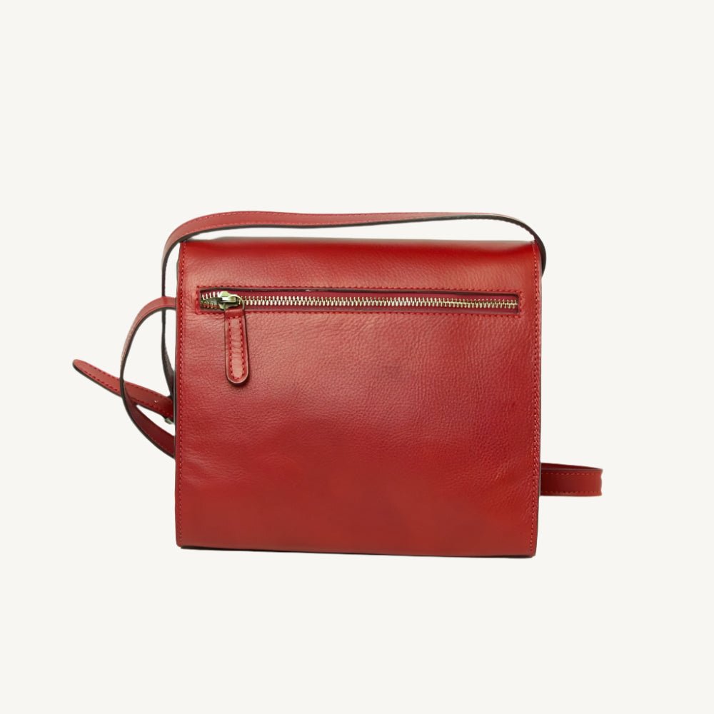 "Full-grain calfskin leather shoulder bag with three compartments, zip closure, rear zip pocket, and adjustable strap"